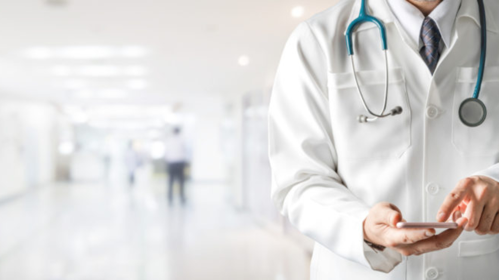 Male doctor using mobile phone at hospital. Medical healthcare and doctor service.